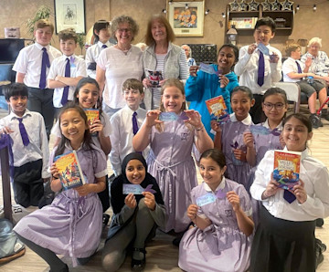 Pictured: Didsbury's Book Buddies welcome author Liz Kessler (centre, left) to Belong Morris Feinmann care village  