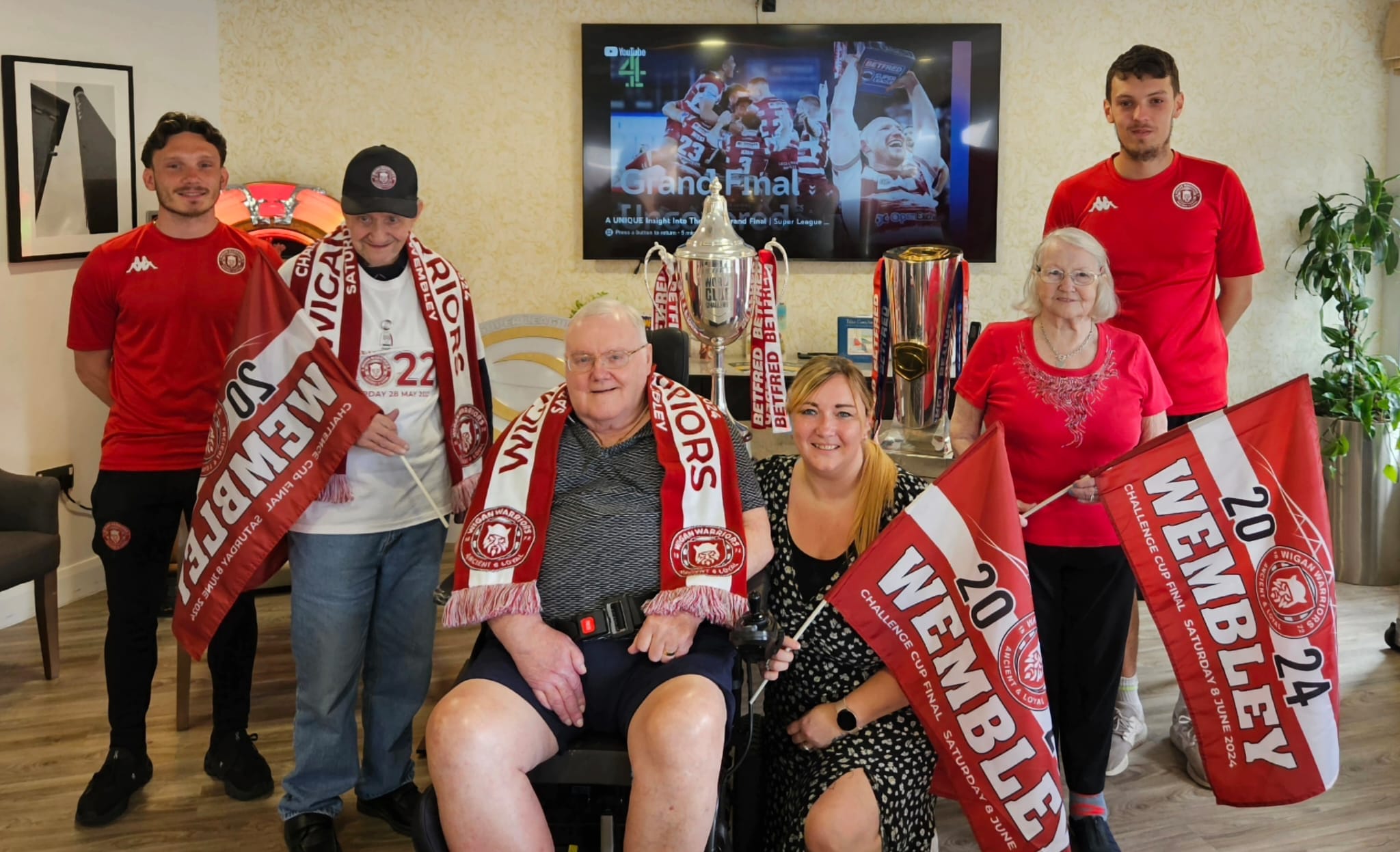 Pictured: Belong Atherton customers Peter, Ken and Dorothy with experience coordinator, Kim Calland (centre, right) and Wigan Warriors Community Foundation's Tyler Roberts (far left) and Jack Corless (far right).
