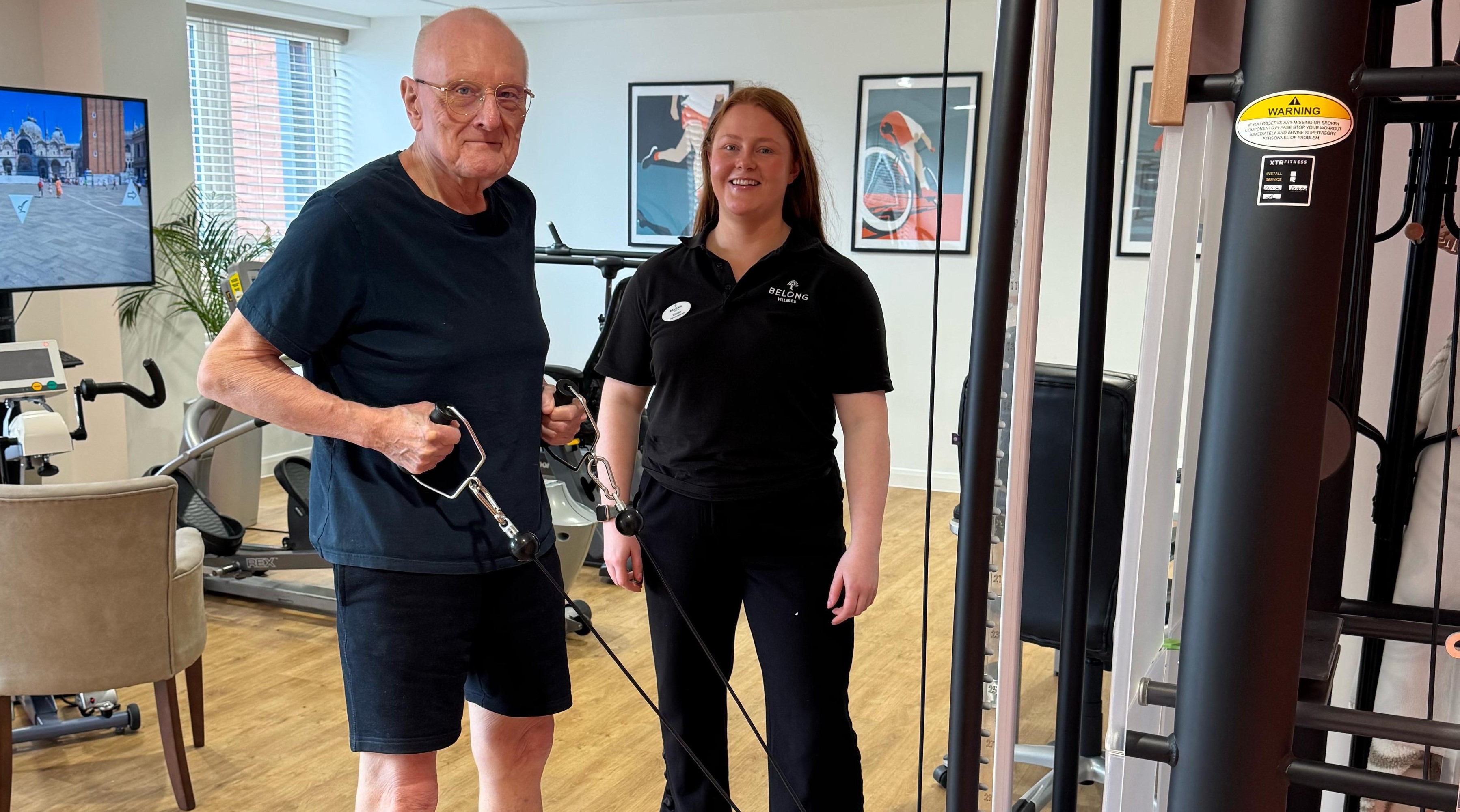 Tony and exercise specialist Louise Warr in the Gym at the Belong care village 