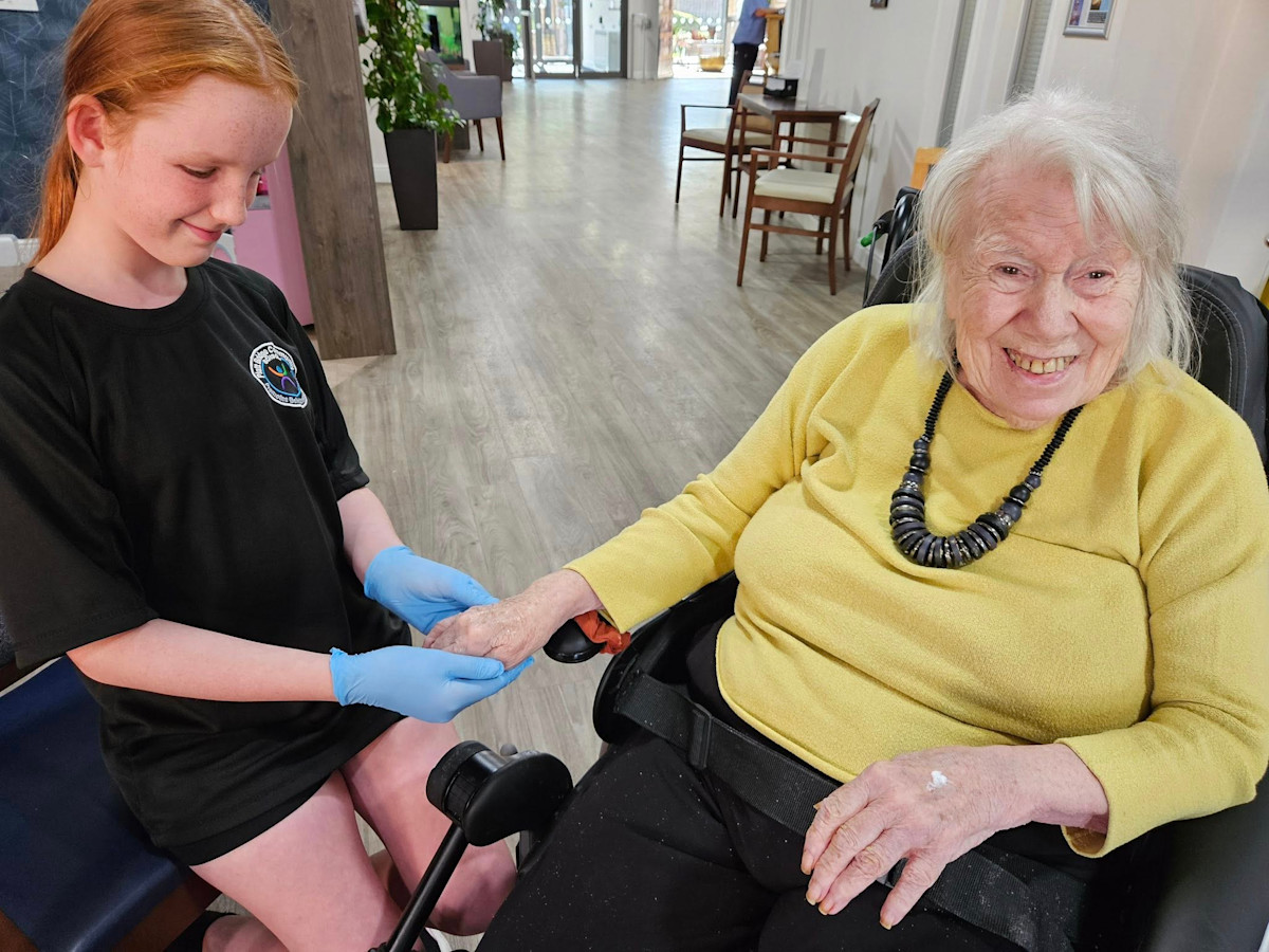 Belong Wigan's Eileen Lyon enjoys a hand massage from her new friend. 