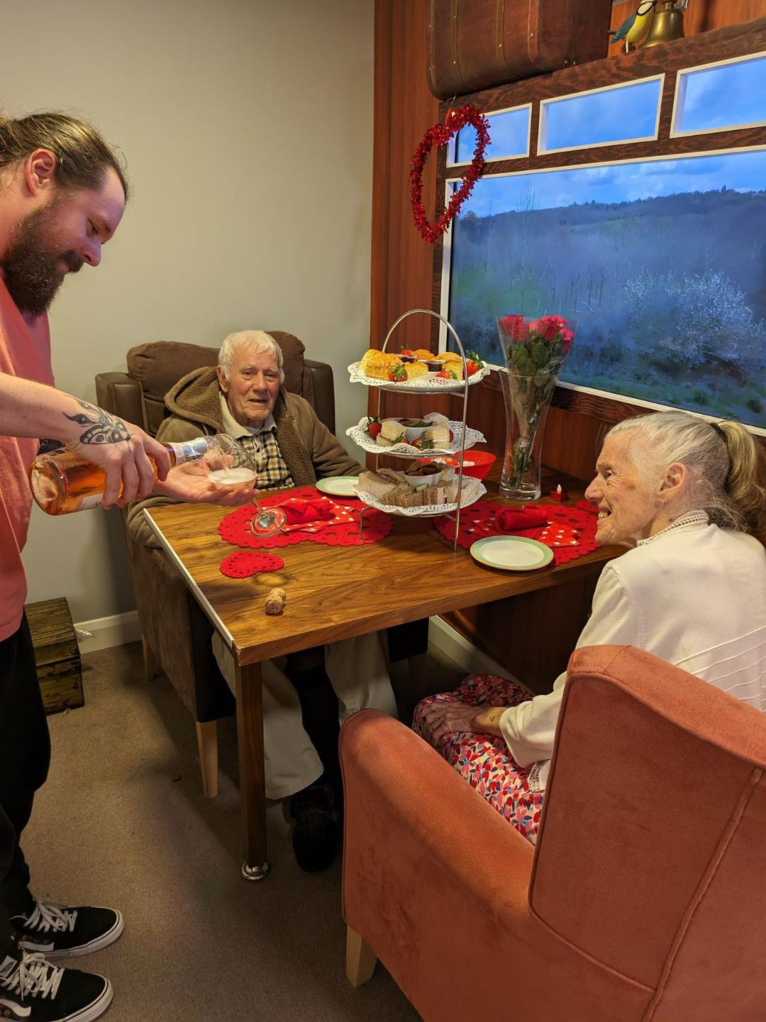 Vera and Frank enjoy their reminiscence train with Belong Warrington support worker, Jamie Barnes 