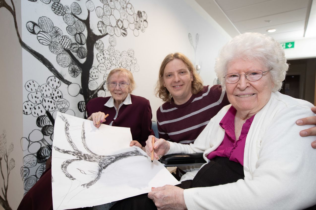 Asset - Belong Newcastle-under-Lyme - (L-R) Resident Evelyn Ball with Belong team member Dan Turner and resident Eileen Walford result result