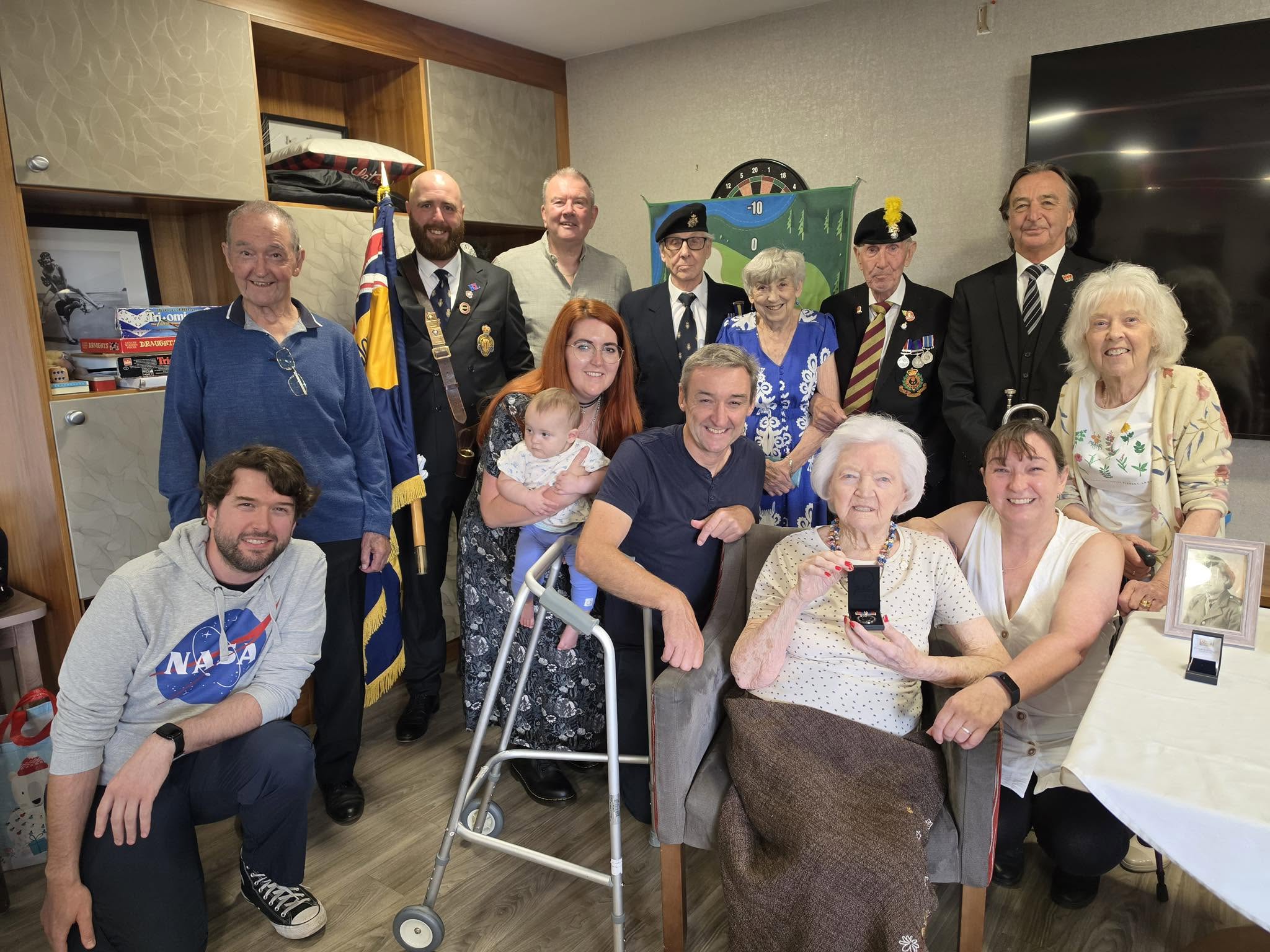 Pictured: Belong Warrington's Marjorie Goodwin celebrates 102 years young with family, friends, and representatives of Grappenhall and Thelwall Royal British Legion (GTRBL) 