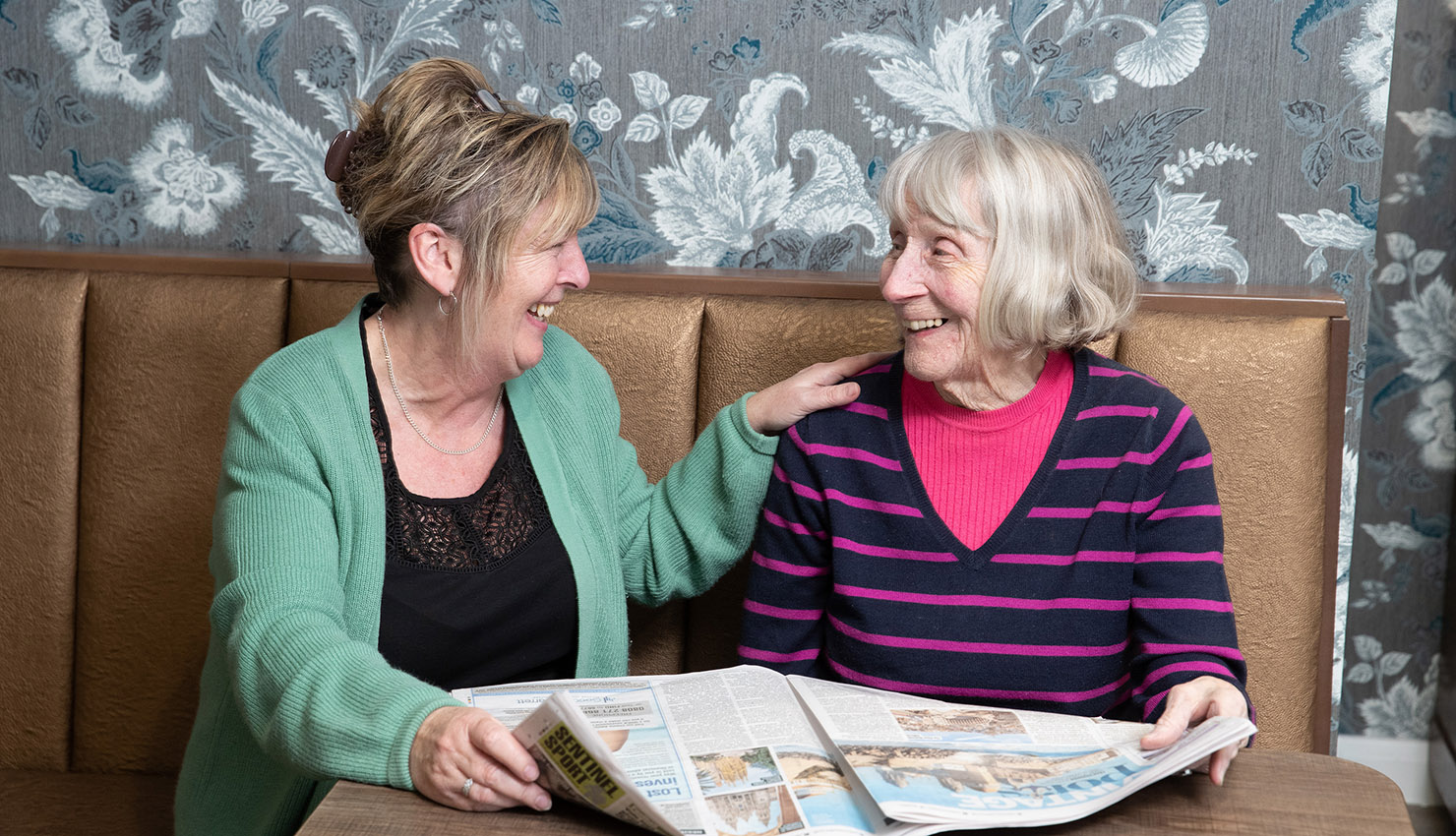 Belong Newcastle-under-Lyme Belong at Home Customer reading the paper
