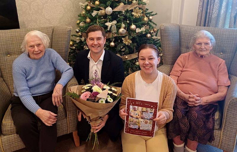 Belong Macclesfield residents and colleagues present their winning Christmas card