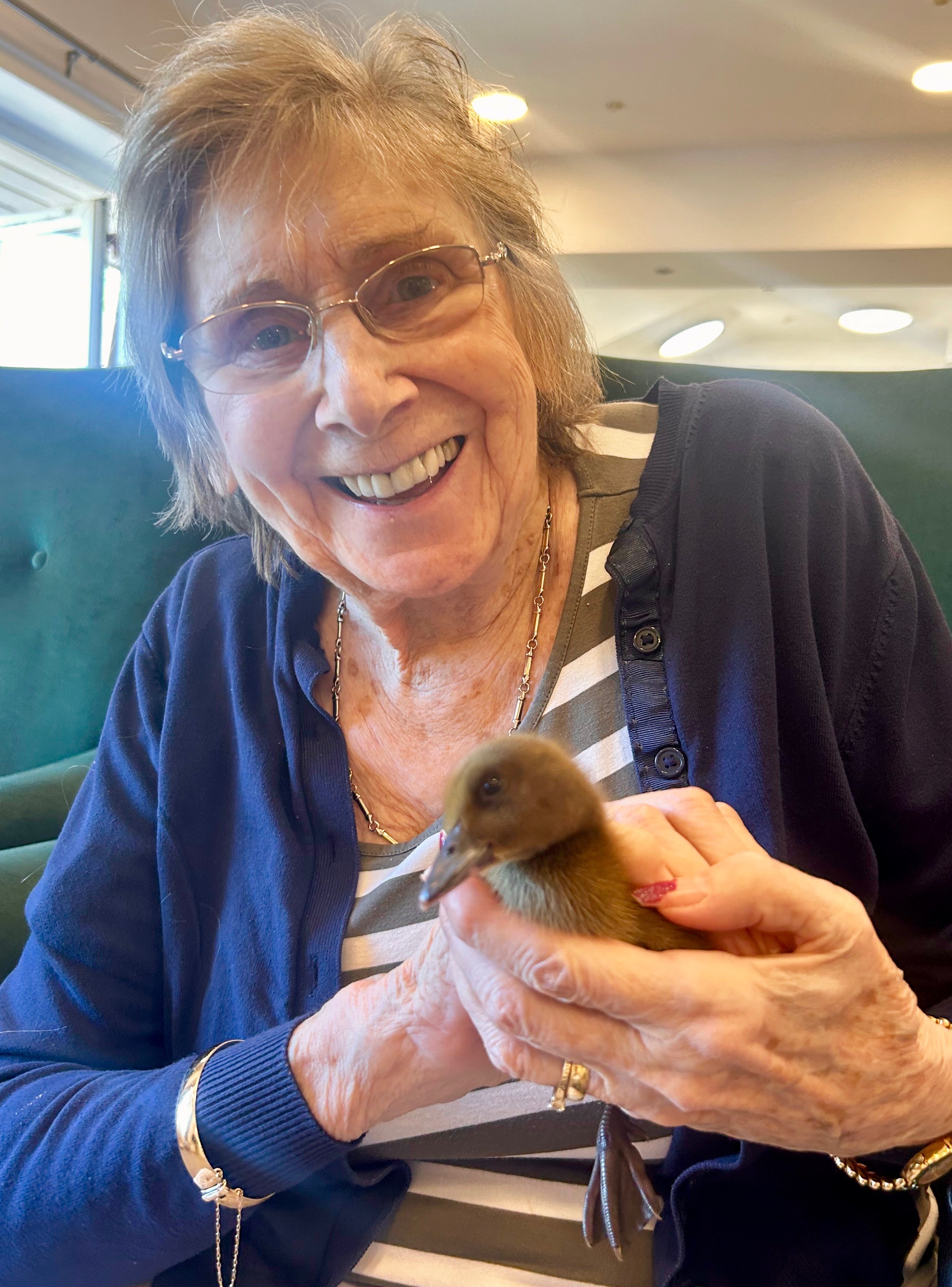 Pictured: Belong Macclesfield customer, Jeanette Bayliss, makes a new feathered friend.