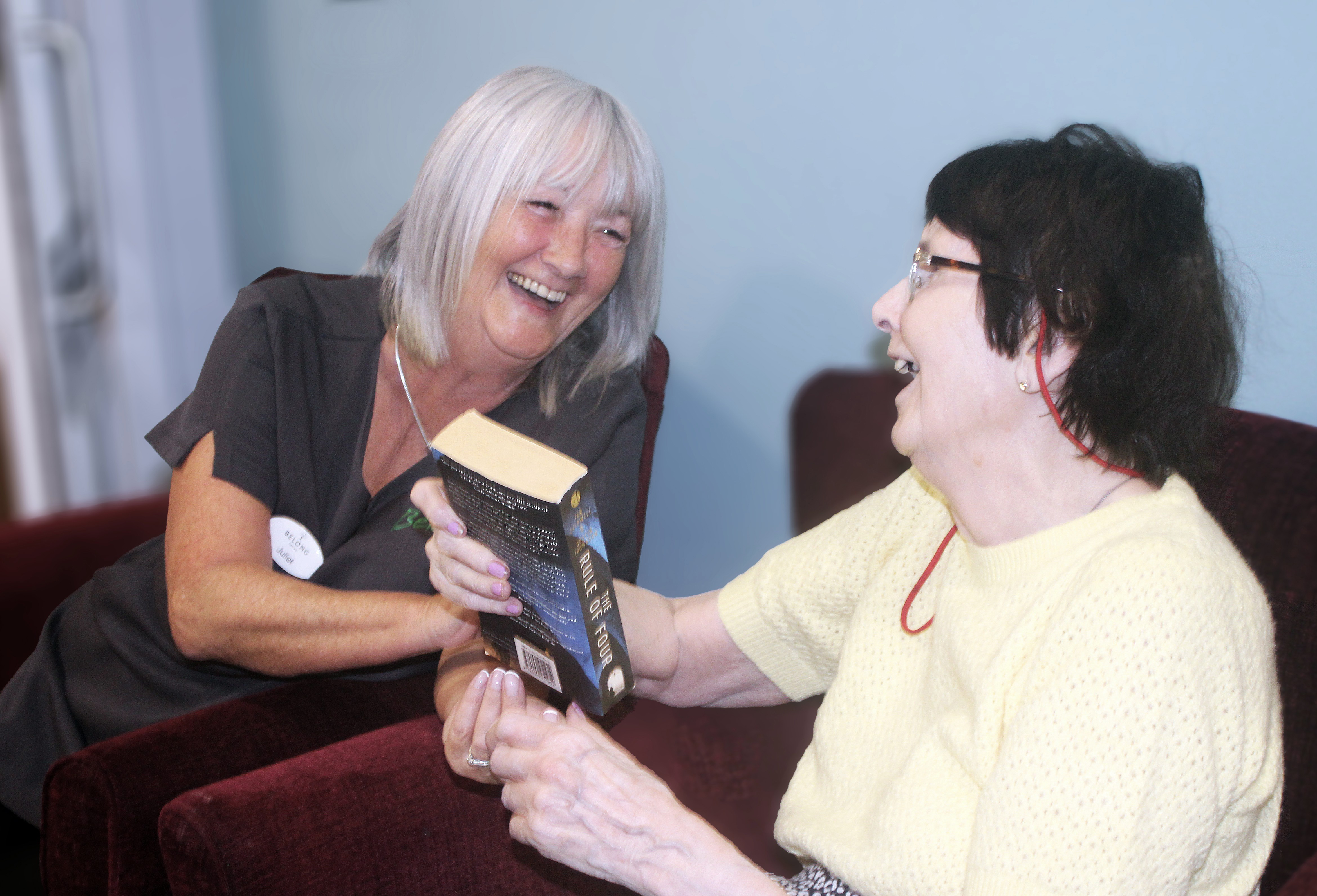 Asset - Belong Crewe - Household - Carer and lady chatting about a book