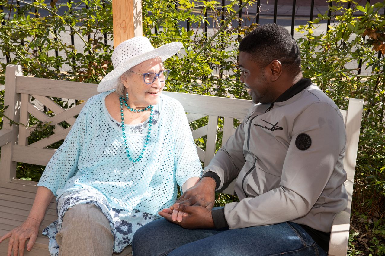 Belong Chester - Carer in the garden with lady in hat