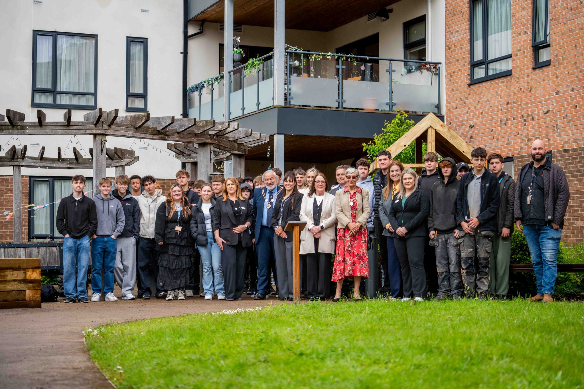 The Newcastle-under-Lyme community at the village's garden launch. 