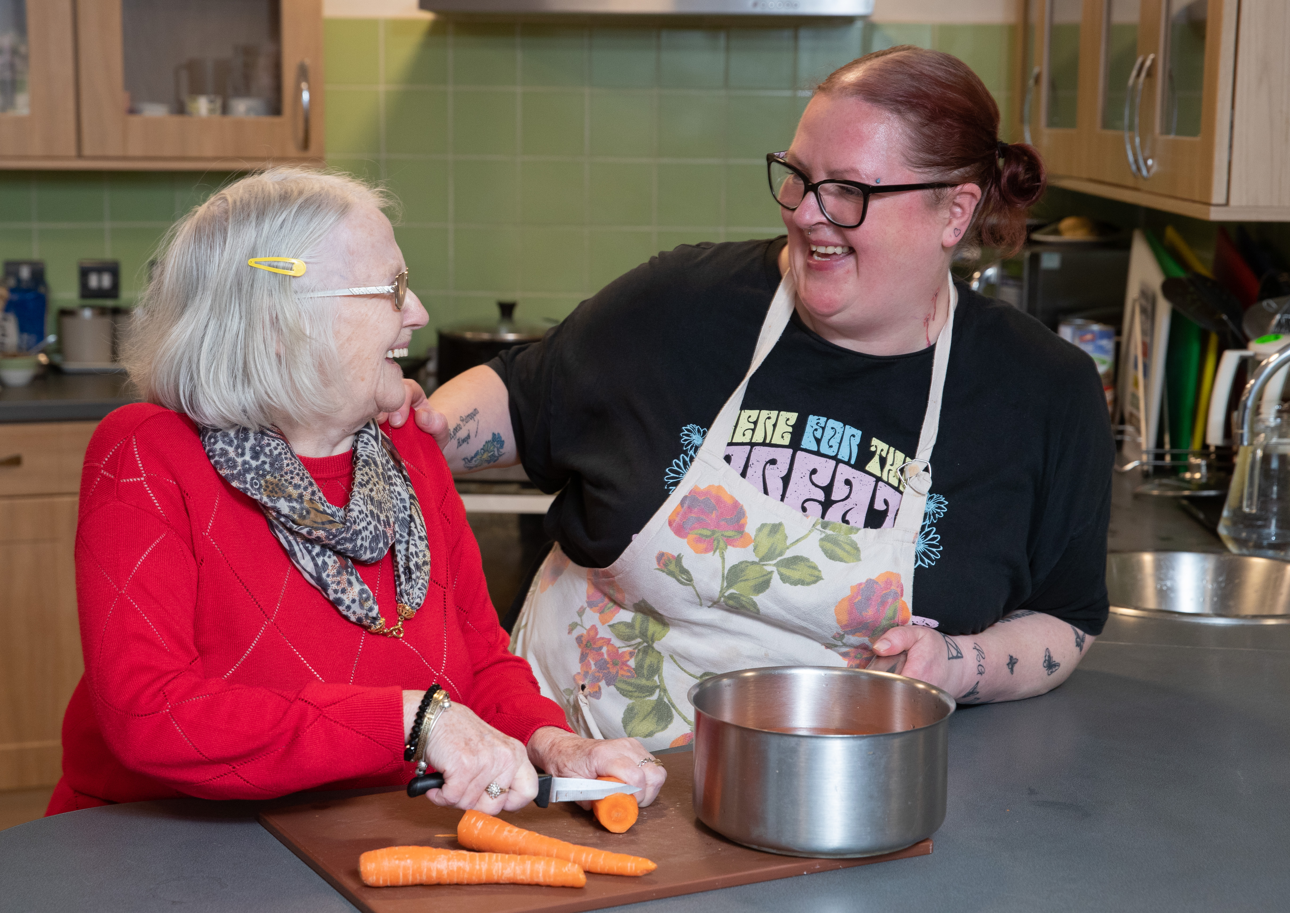 Asset - Belong Atherton - Lady in the household kitchen with a carer